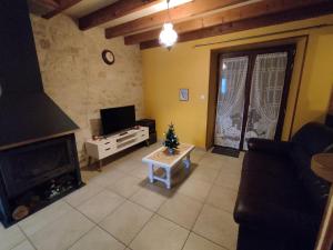 a living room with a fireplace and a christmas tree at Gîte de la Forêt in Saint-Jeanvrin