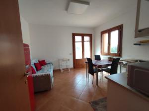 a living room with a couch and a table with chairs at Da Luca in Càbras