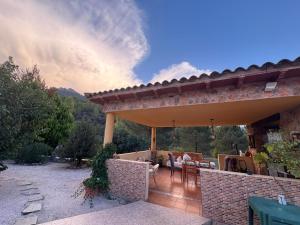 a patio of a house with a table and chairs at Casa Maite in Riópar