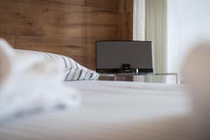 a bedroom with a bed with a television on a table at B&B Portorosso in Monopoli
