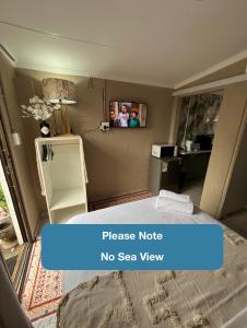 a room with a bed and a no sea view at Ocean Village - No Sea View in Amanzimtoti