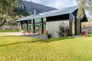 a building with a green lawn in front of it at Da La Babi B&B in Arco