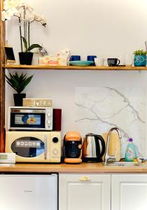 a kitchen counter with a microwave and appliances on it at Sweet cozy studio ultracentral in Cluj-Napoca