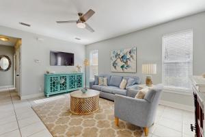 a living room with a couch and a tv at Topsail Village #511 - Beach Moon in Santa Rosa Beach