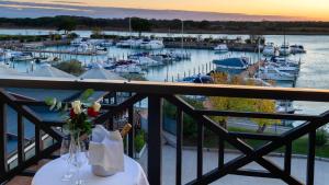 a balcony with a view of a marina with boats at Hotel Marina Uno in Lignano Sabbiadoro +35 photos