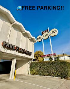 a parking lot with street signs in front of a parking garage at Park Plaza Lodge in Los Angeles +51 photos