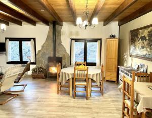 a dining room with a table and a fireplace at Casa Enry in Alcalá de la Selva