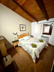 a bedroom with a large bed and a window at Casa Enry in Alcalá de la Selva
