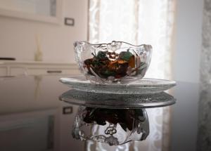 a glass bowl on a stand in a kitchen at La Locanda del Baffo in Capua