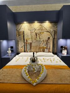 a bedroom with a bed with a painting on the wall at Odeon Neapolis - Historic Suites in Roman Theater in Naples