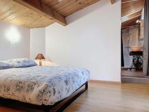 a bedroom with a bed and a bathroom with a piano at Coeur de pierre in Vallon-Pont-dʼArc