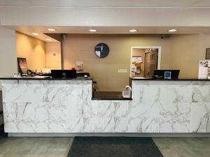 a lobby with a white marble counter top at Ashbourne Hotel Canton Hall of Fame I-77 in Canton