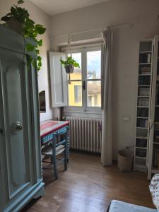 a living room with a table and a window at La Campana in Impruneta +12 photos