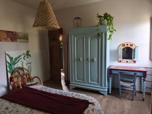 a room with a blue cabinet and a table at La Campana in Impruneta