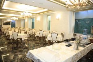 a banquet hall with tables and chairs in a room at HOTEL BOCA Center in Tirana