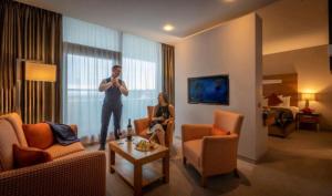 a man standing in a hotel room with a microphone at Clayton Hotel Galway in Galway