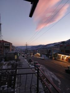 a city street with cars parked on the side of the road at Elite Guest House in Goris