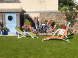 a group of lawn chairs sitting in the grass at Morbreizh 1 in Paimpol +2 photos