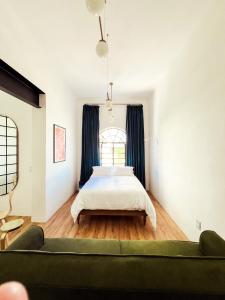 a bedroom with a bed and a couch at La Casona in Guadalajara