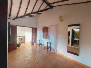 a hallway with a table and chairs in a room at Casa Real Barichara in Barichara +20 photos