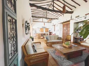 a living room with a couch and a table at Casa Real Barichara in Barichara