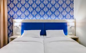 Postel nebo postele na pokoji v ubytování ibis Styles Rastatt Baden-Baden