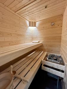 a wooden sauna with a stove in it at La Tzoumaz Lodge in La Tzoumaz +48 photos