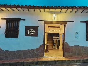 an entrance to a building with a sign on the wall at Casa Real Barichara in Barichara