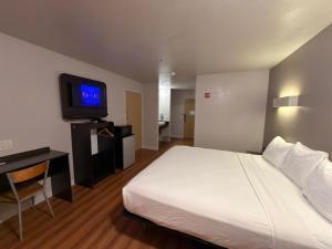 a hotel room with a bed and a tv at Americas Best Value Inn Apache Junction in Apache Junction