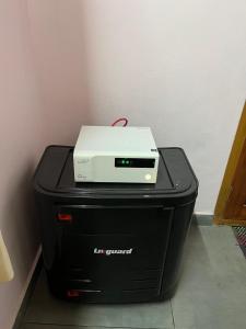 a printer sitting on top of two black systems at Writer's Inn in Vaikom