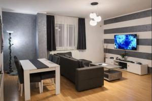 a living room with a couch and a table at Apartman MARY in Belgrade
