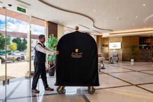 a man standing next to a large black object in a lobby at Imperial - إمبريال in Riyadh