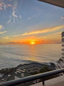 a sunset from the balcony of a condo at Club Villamar Exclusive Beachfront Penthouse in Adeje