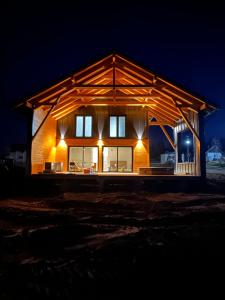 a house that is lit up at night at Cabana Aurora in Topliţa