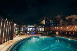 a swimming pool in a hotel at night at Pavilion Palace Hotel in Dubai