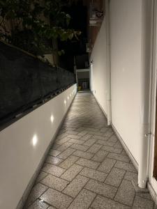 a hallway with a white wall and a tile floor at Casa Gallo in Cala Gonone