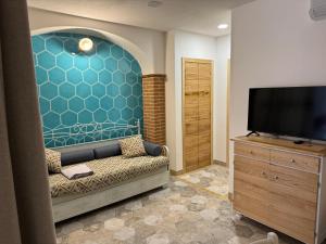 a living room with a couch and a flat screen tv at Casa Gallo in Cala Gonone