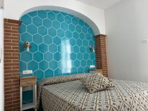 a bedroom with a blue headboard and a bed at Casa Gallo in Cala Gonone