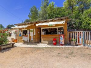 a shop with a red fire hydrant in front of it at ZEcamping 3 étoiles avec terrain multisports mini golf 2km plage dog friendly in Cargèse +35 photos