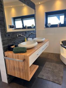 a bathroom with a sink and a mirror at Villa Belmonte in Weilheim an der Teck +21 photos