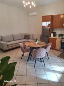 a kitchen and living room with a table and chairs at Kerkis View House in Karlovasi