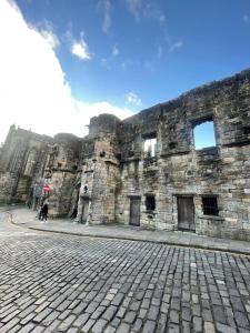 a large stone building with a person standing in front of it at Hidden Gem in Stirling