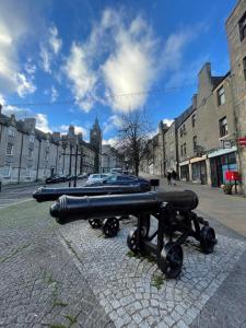a cannon sitting on the side of a street at Hidden Gem in Stirling +11 photos