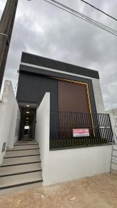 a black and white building with stairs and a window at Residencial Roberto Luiz Chiodi in Campos Novos +5 photos