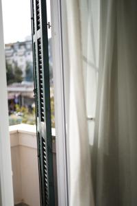 a view of a window with a curtain at HOTEL BOCA Center in Tirana