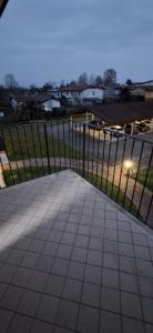 a fence in front of a yard with a sidewalk at Chiara Apartment in Cervignano with 2 Double Beds in Cervignano del Friuli