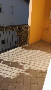 a room with a tiled floor and a wall at Chiara Apartment in Cervignano with 2 Double Beds in Cervignano del Friuli