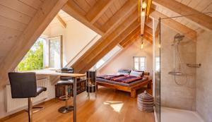 a attic bathroom with a shower and a bed at Die Blaue Pause 29 in Weißenstadt