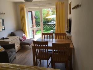 a living room with a dining room table and chairs at The River Flat in Oxford