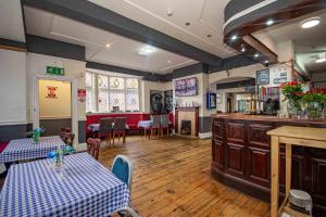 a restaurant with two tables and a bar in a room at The Stag and Hen Pub in Coventry